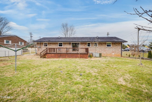 back of house featuring central AC unit, a fenced backyard, a yard, a wooden deck, and brick siding