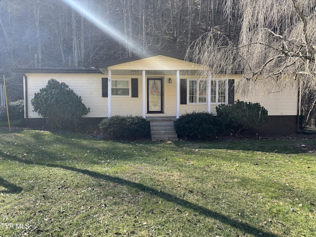 view of front of house featuring covered porch and a front lawn