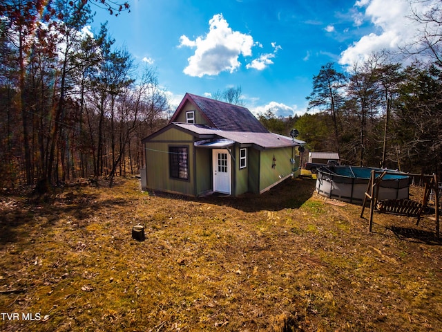 view of outbuilding featuring an outdoor pool