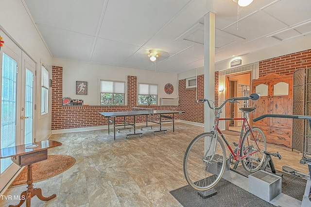 game room with brick wall