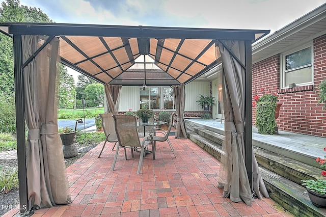 view of patio featuring a gazebo and outdoor dining area