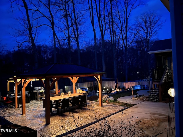 view of patio / terrace with a gazebo, outdoor dining area, and fence