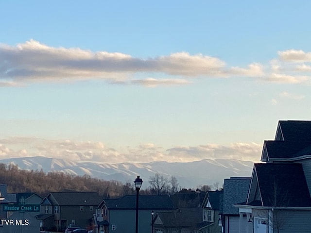 view of water feature with a residential view and a mountain view