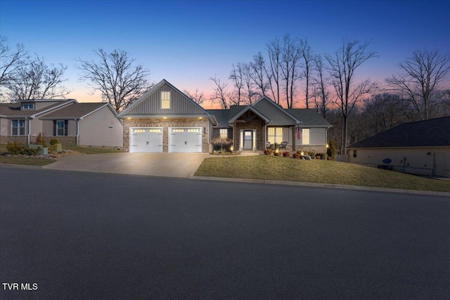 craftsman house with concrete driveway, a garage, and a front lawn