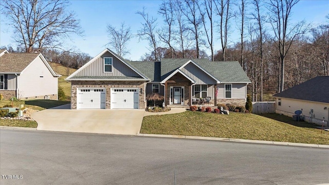 craftsman-style home with a front yard, driveway, an attached garage, a shingled roof, and board and batten siding