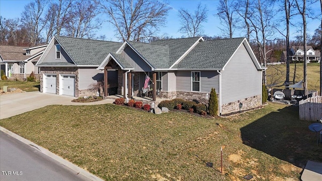 craftsman-style home with driveway, stone siding, covered porch, a front yard, and a shingled roof