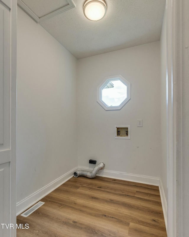 washroom featuring laundry area, washer hookup, wood finished floors, visible vents, and baseboards