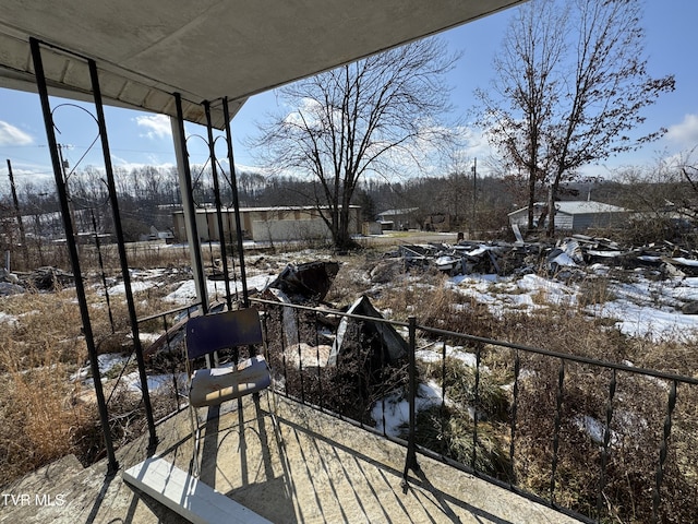 view of snow covered back of property