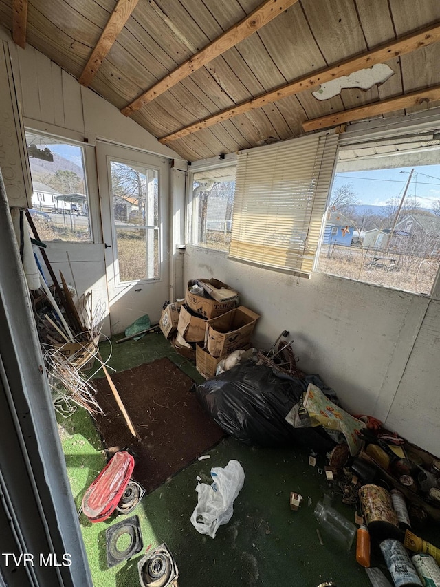 unfurnished sunroom featuring wood ceiling and vaulted ceiling