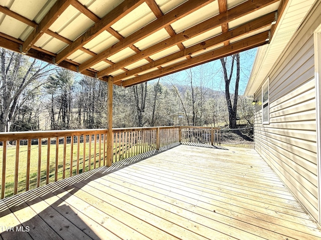 wooden terrace featuring a yard