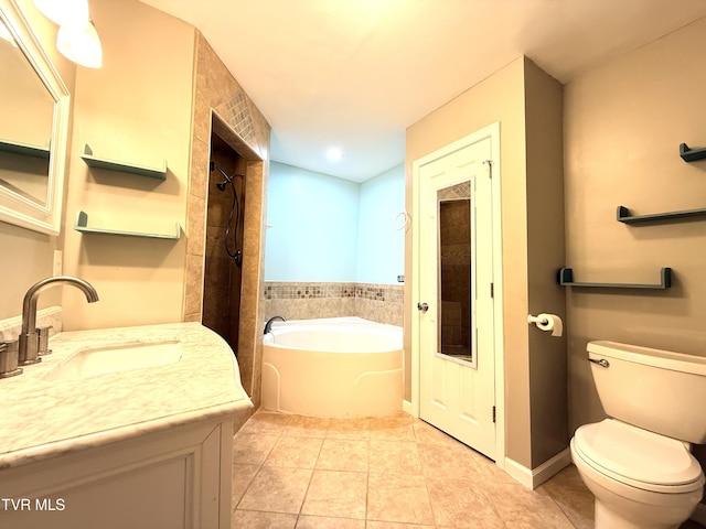 bathroom with a garden tub, toilet, vanity, tiled shower, and tile patterned floors