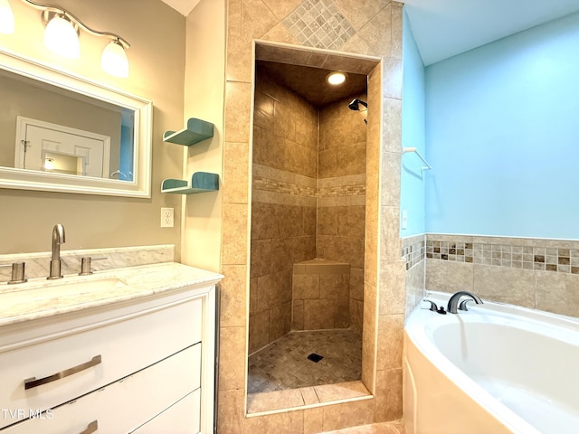 full bath featuring tiled shower, a garden tub, and vanity