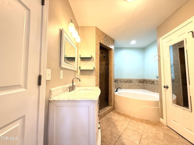 full bath featuring a garden tub, a shower stall, tile patterned flooring, and vanity