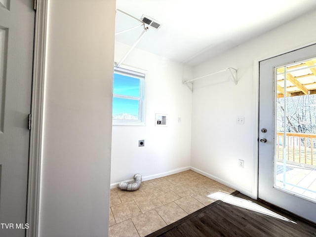 clothes washing area featuring hookup for a washing machine, hookup for an electric dryer, laundry area, visible vents, and baseboards