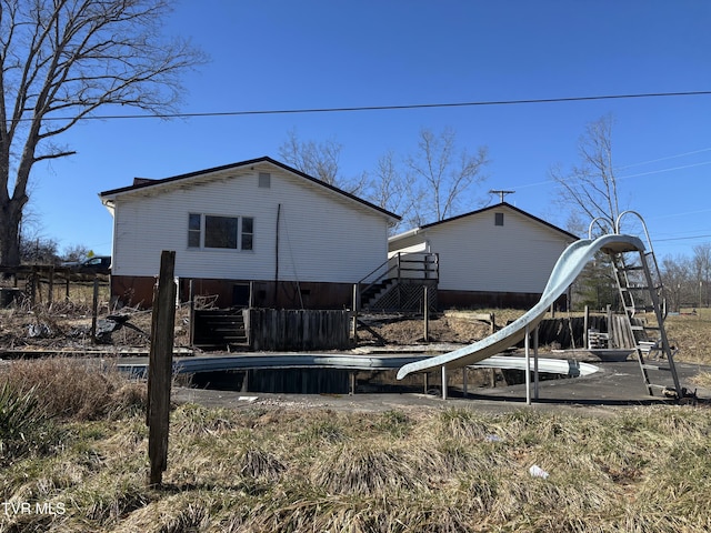 rear view of property featuring stairway