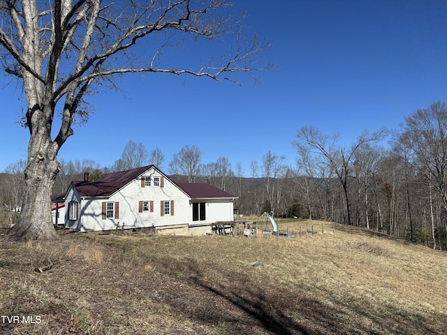 back of house featuring a chimney