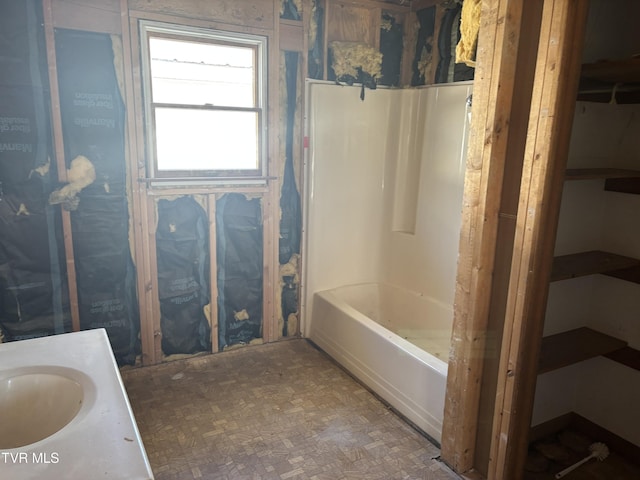 bathroom with a bathing tub, vanity, and walk in shower