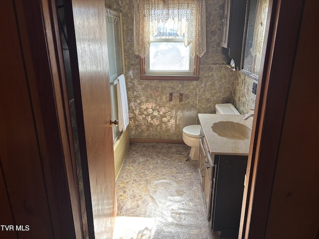 bathroom featuring wallpapered walls, baseboards, toilet, shower / bathing tub combination, and vanity