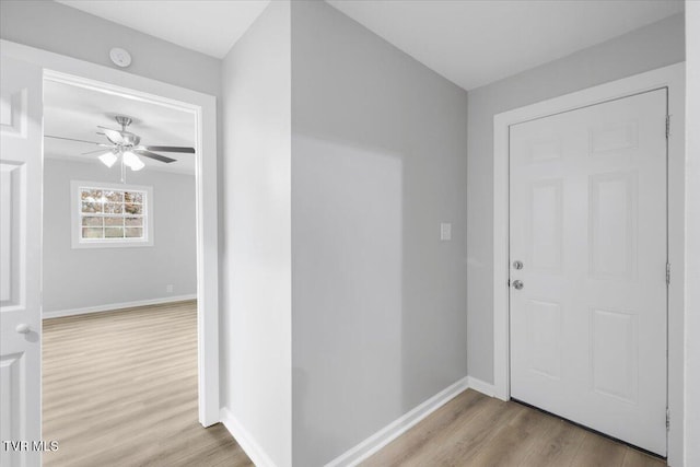 entrance foyer featuring ceiling fan, baseboards, and wood finished floors