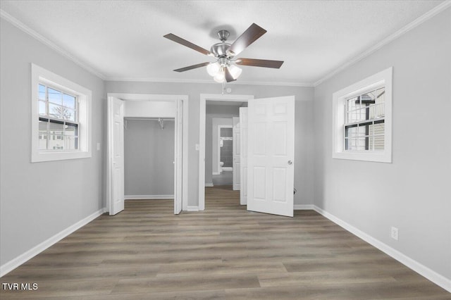 unfurnished bedroom with ornamental molding, baseboards, and wood finished floors