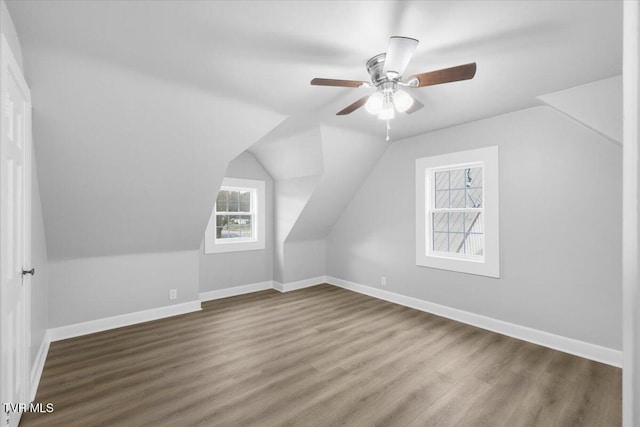 bonus room featuring lofted ceiling, ceiling fan, wood finished floors, and baseboards