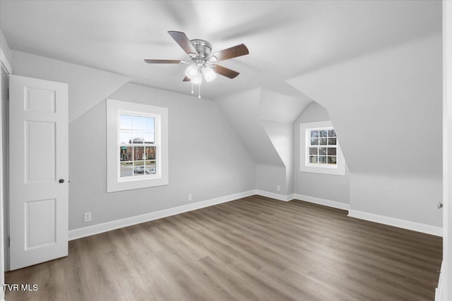 bonus room featuring a wealth of natural light, baseboards, and wood finished floors