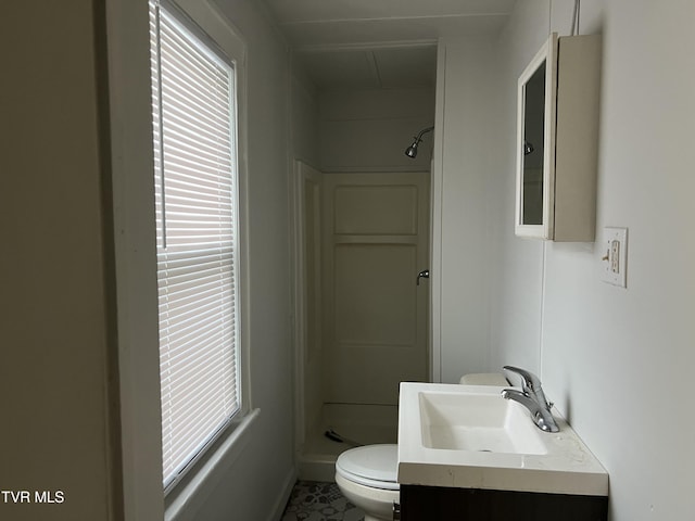 full bathroom with toilet, a stall shower, and vanity