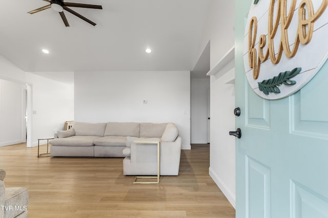 living area with light wood-type flooring, ceiling fan, and recessed lighting