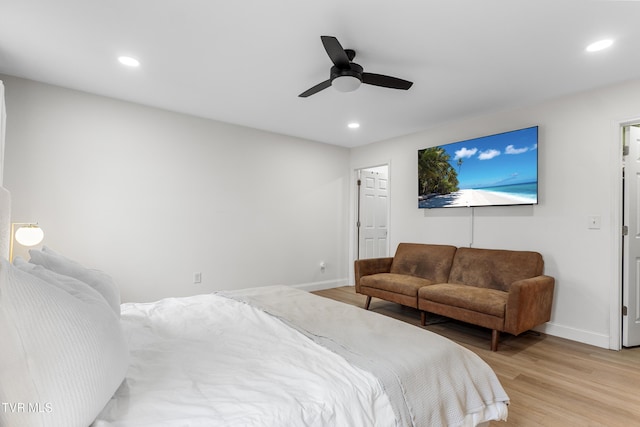 bedroom with light wood-type flooring, baseboards, and recessed lighting