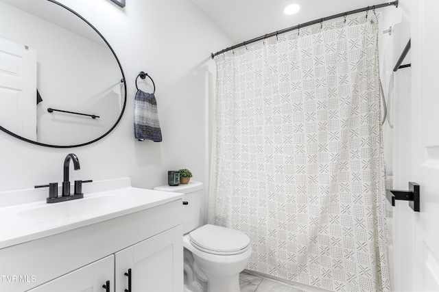 bathroom featuring toilet, a shower with shower curtain, and vanity