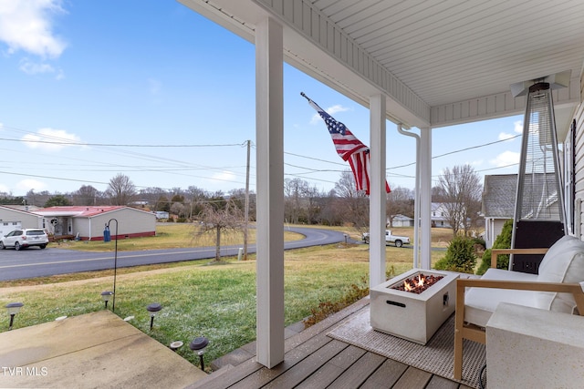 exterior space featuring a fire pit and a yard