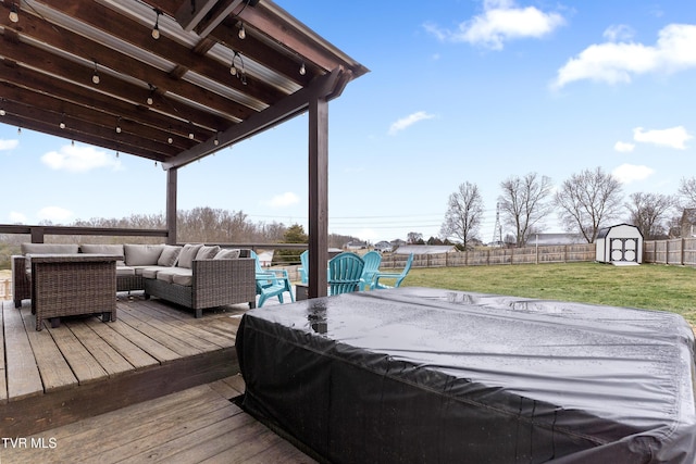 deck with an outbuilding, a yard, a storage unit, an outdoor hangout area, and a fenced backyard