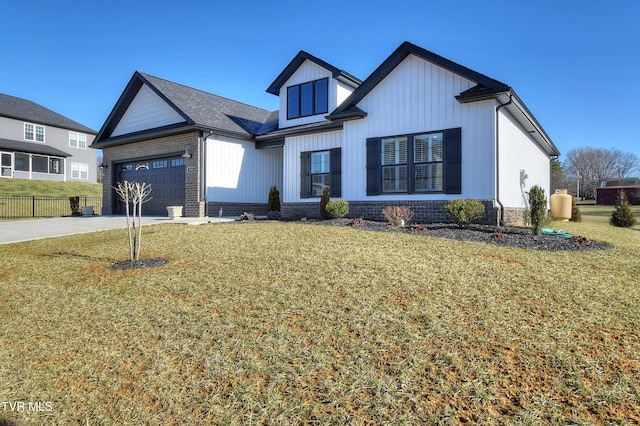 modern farmhouse style home featuring brick siding, a front lawn, fence, concrete driveway, and a garage