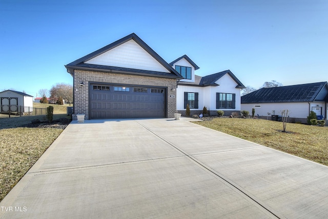 modern farmhouse style home with board and batten siding, concrete driveway, a front yard, a garage, and brick siding