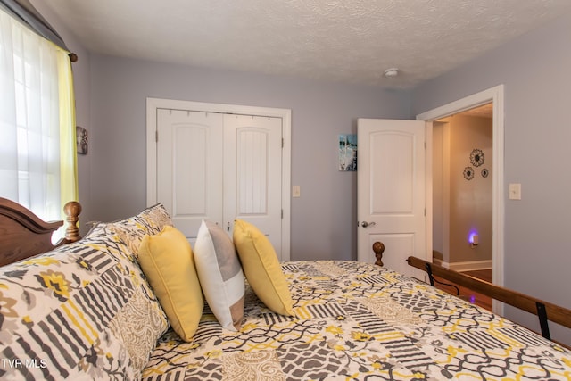 bedroom featuring a textured ceiling and a closet