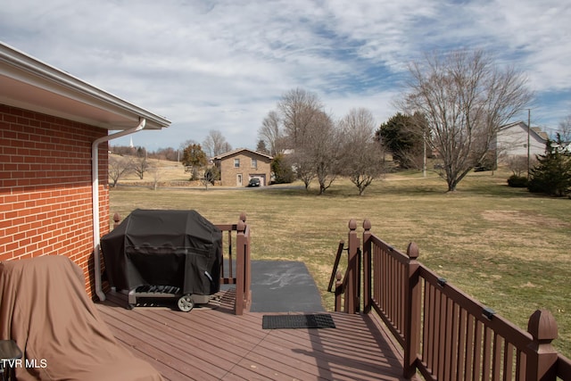 wooden terrace with a yard and grilling area