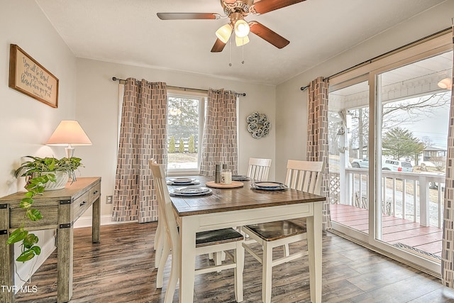 dining room featuring a ceiling fan, baseboards, and wood finished floors