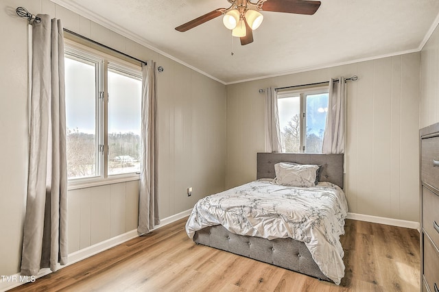 bedroom featuring crown molding, baseboards, and wood finished floors