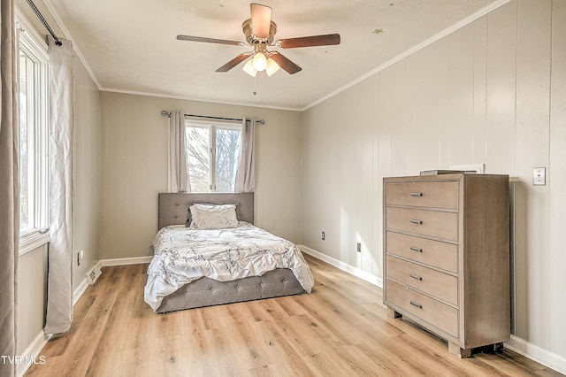 bedroom with light wood-style floors, baseboards, and ornamental molding