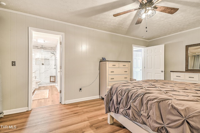 bedroom with a textured ceiling, baseboards, light wood-type flooring, ensuite bath, and crown molding