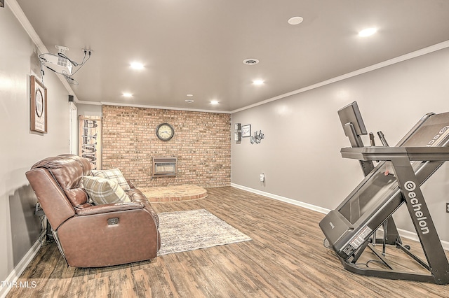 interior space with crown molding, recessed lighting, brick wall, wood finished floors, and baseboards