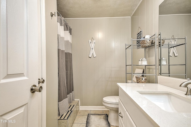 bathroom featuring a shower with curtain, toilet, a textured ceiling, vanity, and tile patterned flooring