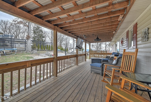 deck featuring a trampoline and fence