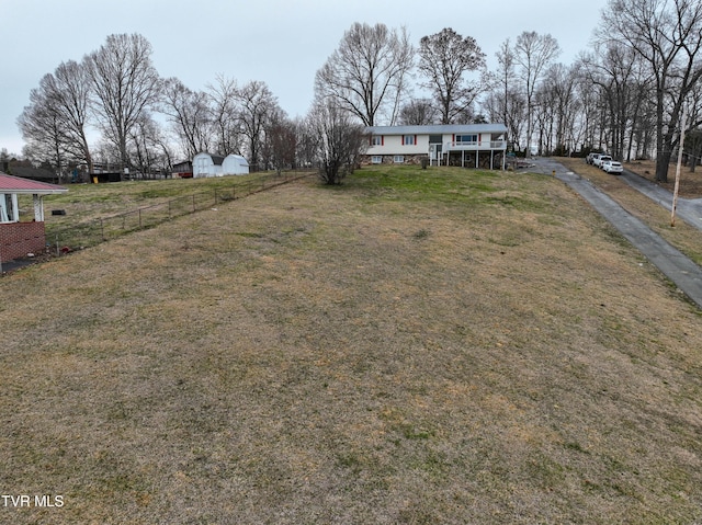 view of front facade with a front yard and fence