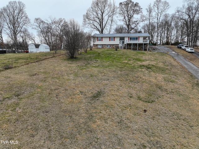 view of front facade with a front yard and fence