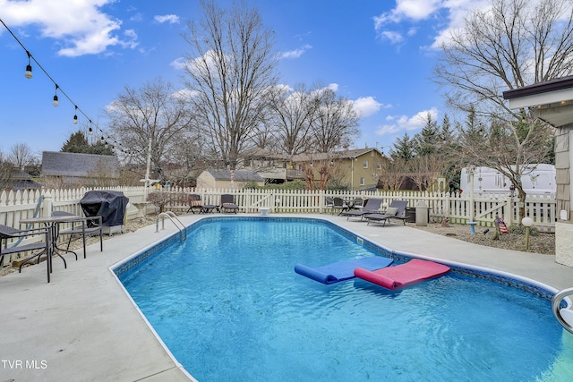 view of swimming pool with a patio area, a fenced backyard, grilling area, and a fenced in pool