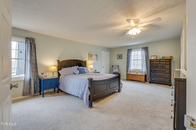 bedroom with a textured ceiling, carpet, a ceiling fan, and baseboards