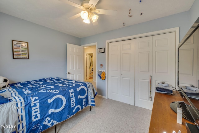 carpeted bedroom featuring ceiling fan and a closet