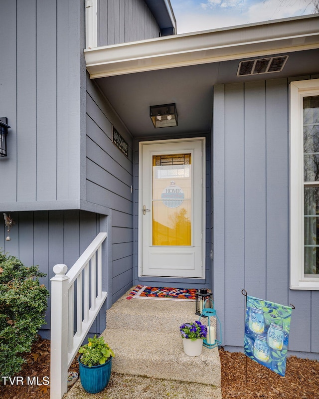 property entrance featuring board and batten siding and visible vents