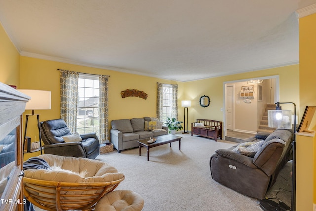 carpeted living room featuring stairs, plenty of natural light, a glass covered fireplace, and crown molding